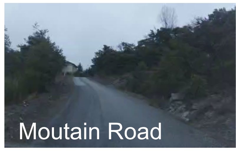 Narrow mountain road without lane lines